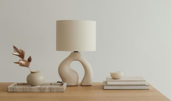 a lamp, stack of books, and decor