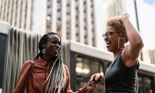women laughing together in the city