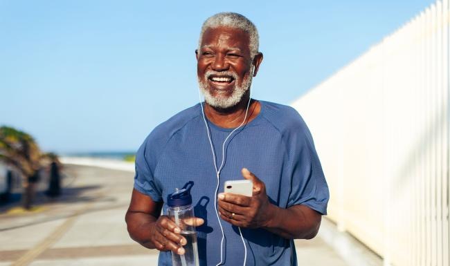 a man holding a water bottle while outdoors
